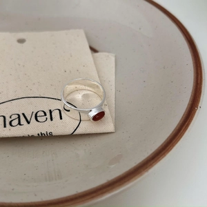 925 Sterling silver wide band ring with oval red agate on rustic linen and ceramic background