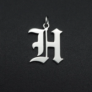 Detailed macro view of a silver stainless steel Old English letter H pendant with ring