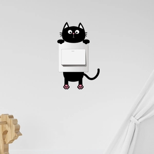 Detail showing a black cartoon cat wall sticker with pink paws around a light switch