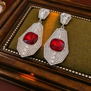 Vintage silver earrings with large red square gemstone and rhinestones on green velvet