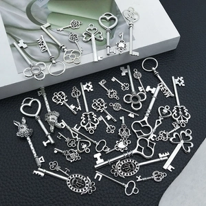 Macro view of assorted vintage zinc alloy key charms with DREAM engraving on black background