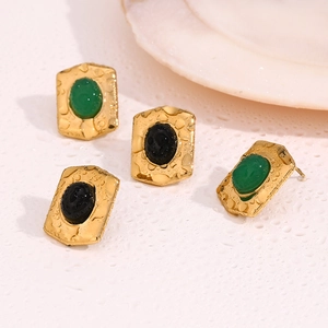 Detailed shot of vintage geometric 18K gold plated earrings with oval gemstone inlays