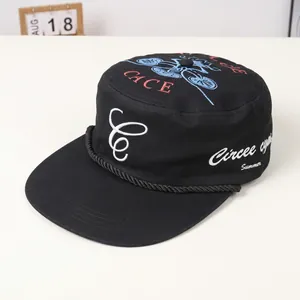 Close-up of black cotton cadet cap with CACE embroidery and braided cord detail