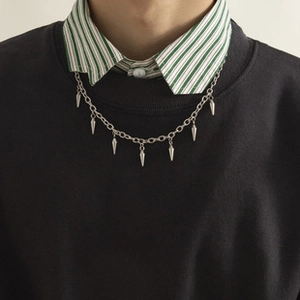 Close-up of minimalist stainless steel O-chain necklace with hanging spike pendants