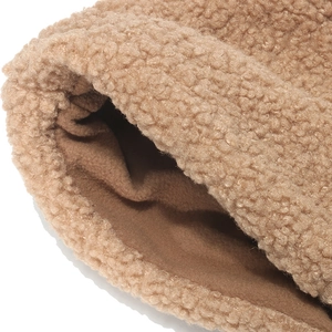 Detailed view of thick teddy fleece exterior and soft polar fleece lining on winter hat