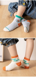 Close-up of breathable mesh cotton socks for kids featuring green and orange patterns