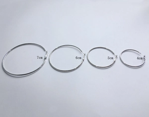 Detailed size comparison of 4cm to 7cm silver hoop earrings set in a flat lay view