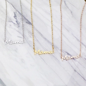 Three minimalist Mama necklaces in silver, gold, and rose gold on white marble background