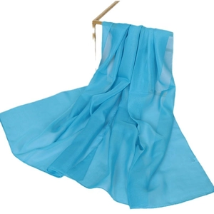 Solid blue lightweight chiffon scarf displayed on a metal rack with soft translucent texture