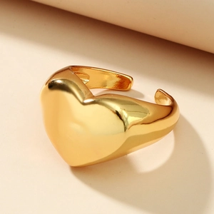 Macro detail of 3D heart-shaped gold-plated open ring with a polished finish