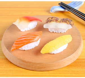 Detailed top view of realistic PVC sushi models on a round wooden tray with chopsticks