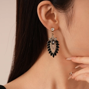 Detail of vintage drop earring with black water drop stone and white zircon accents