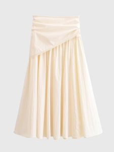 Detailed view of cream-colored maxi skirt with diagonal tiered lace layers and soft ruffles