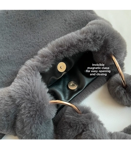 Close-up of the hidden magnetic closure and soft grey faux fur texture on a winter tote bag