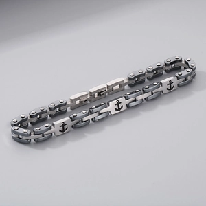 Detailed close-up of a men's stainless steel chain bracelet featuring an anchor motif