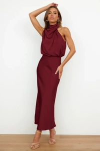 Detailed view of burgundy satin sleeveless maxi dress showing elegant neck drape and texture