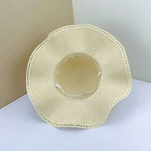 Macro detail of beige straw hat with scalloped lace edge and elastic chin strap