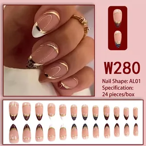Almond-shaped French press-on nails with leopard print and golden metallic curves