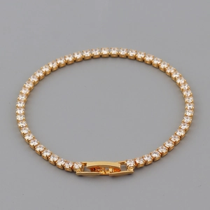 Detail of gold tennis bracelet with cubic zirconia stones and secure square clasp