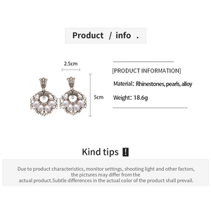Detail view of retro geometric pearl earrings with measurements of 2.5cm width and 5cm height