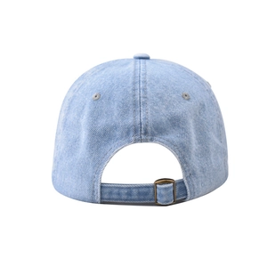 Detail of light blue washed denim baseball cap featuring an adjustable metal buckle