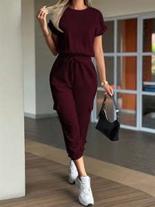 Detail view of dark red two-piece tracksuit with short sleeve tee and drawstring cargo pants