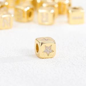 Detail of 18K gold-plated cube spacer bead featuring sparkling zircon star inlay