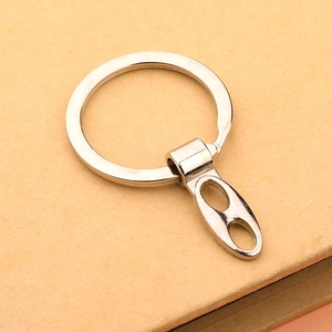 Macro detail of silver metal keychain connector and circular ring on textured paper