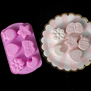 Close-up of a purple silicone mold with star, heart, and flower shapes for DIY crafts
