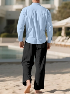 Rear view of light blue linen shirt and black loose pants set for casual beach vacations