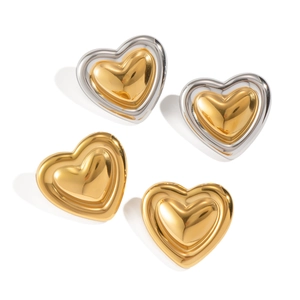 Detailed view of vintage gold and two-tone silver heart studs in metallic finish