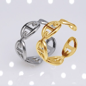 Macro detail of gold and silver stainless steel chain link rings with adjustable opening