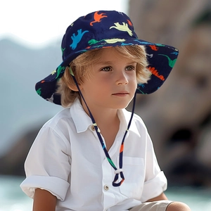 Detail of kids sun hat with colorful dinosaur prints and adjustable chin strap