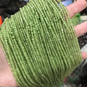 Close-up of sparkling 2-3mm light green crystal square beads for DIY jewelry making