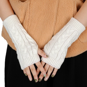 Detailed knit texture of cream cable knit fingerless gloves showing wrist length and weave