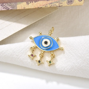 Detail of gold Evil Eye pendant with colorful star charms on white textured fabric