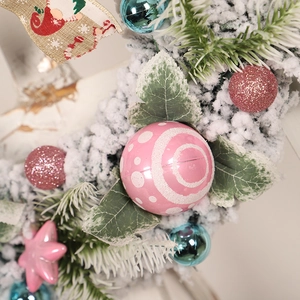 Flocked PVC Christmas wreath with pink and blue ornaments and decorative linen bow