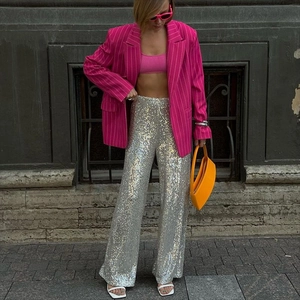 Detail of shimmering silver sequin straight-leg trousers with a stylish metallic finish