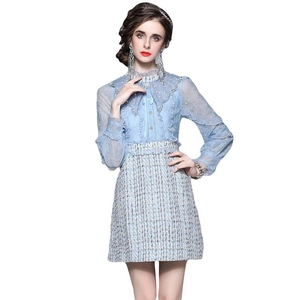Blue tweed dress with lace sleeves and embroidery detail on a white background