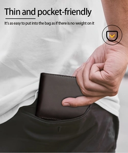 Slim vintage leather wallet shown easily sliding into a pocket to highlight thin design