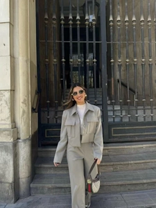 Detail of light gray short work jacket and high waist straight pants in suit fabric