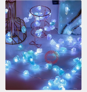 Detail of LED copper wire lights with natural ice blue and lavender crystals
