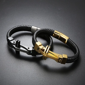 Detail of men's leather bracelets with gold and black mechanical stainless steel clasps