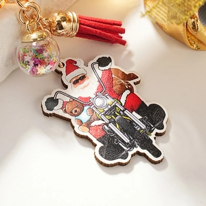 Festive Santa on motorcycle keychain with glass star globe and red tassel decoration
