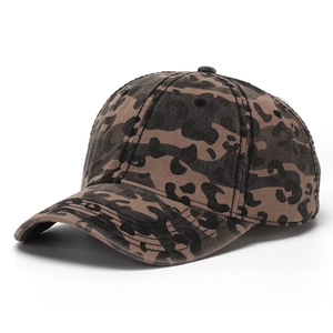 Detail of washed cotton baseball cap featuring vintage camouflage leopard print and curved brim
