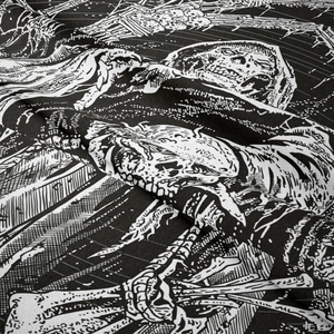 Close-up of black and white gothic skeleton tapestry showing fine woven fabric texture