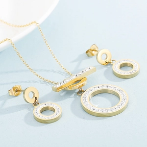 Detail view of gold stainless steel necklace and earrings set with pavé crystals