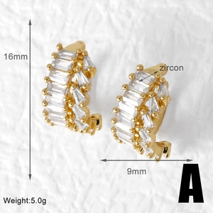 Macro shot of gold-plated C-shaped ear cuffs with rectangular zircon stones and size specs