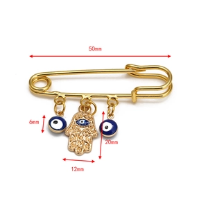 Detail view of Hamsa Hand and Evil Eye gold pin with dimensions 50mm by 20mm