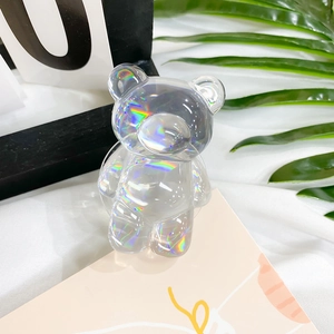 Close-up of bear-shaped holographic laser phone grip with iridescent rainbow reflections